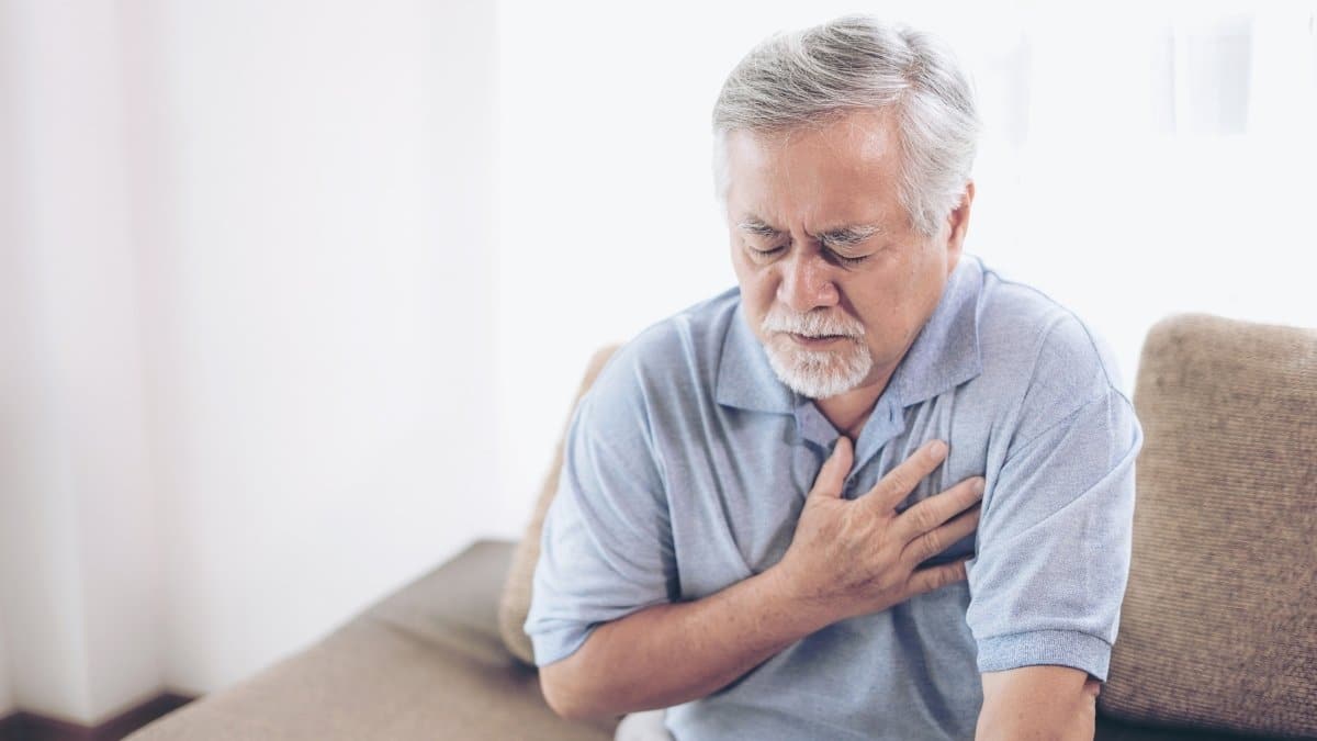 An old man suffering from a heart attack as a direct result of heart diseases.
