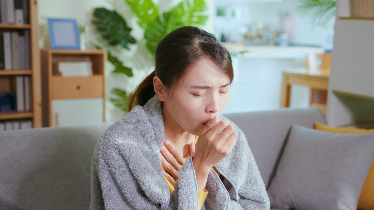 A woman coughing due to infectious disease