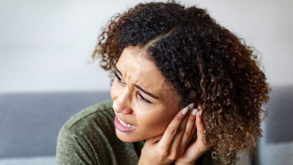 A woman feeling pain in her ear