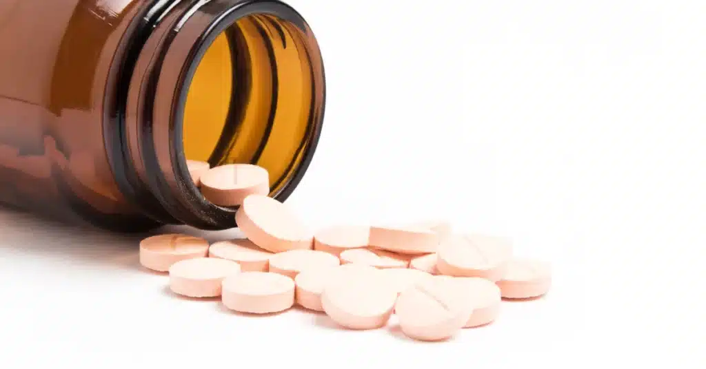pills of zinc spilling out of a bottle