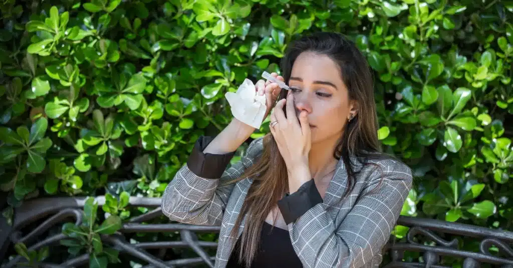 Putting eye drops (suffering from pollen allergy conjuctivitis)