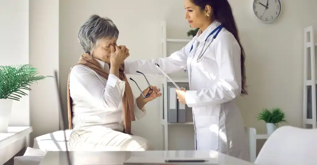 old women consulting with a doctor having eye pain