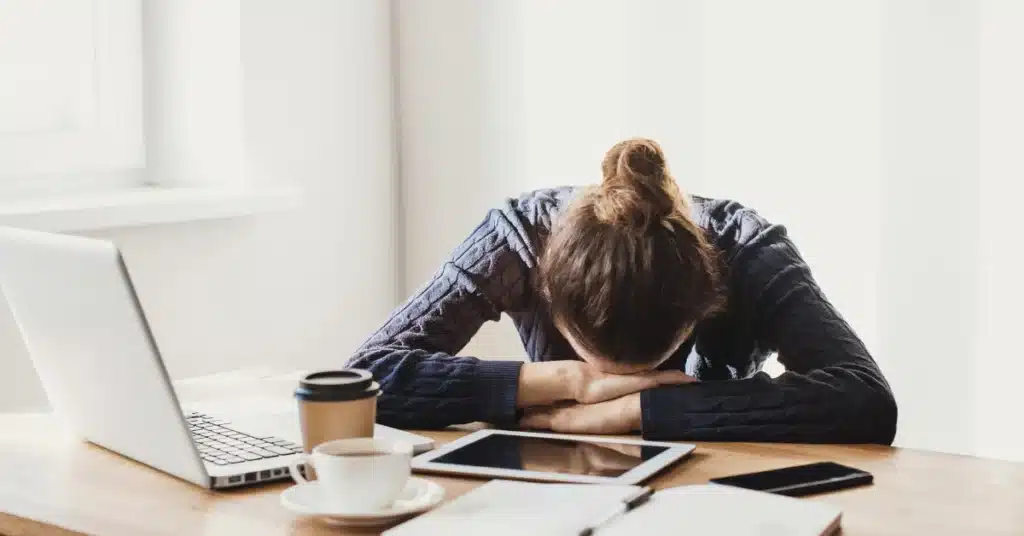 Tired woman laying her head on table