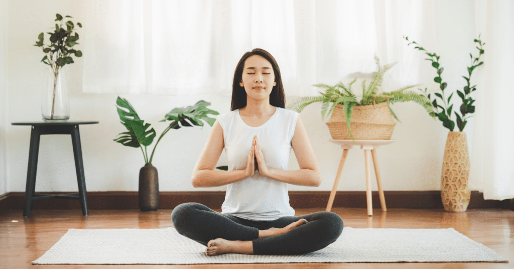 Woman doing yoga at home in living room