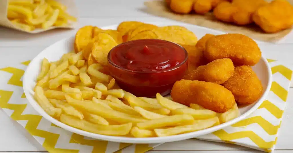 tasty fries and chips lying on the plate