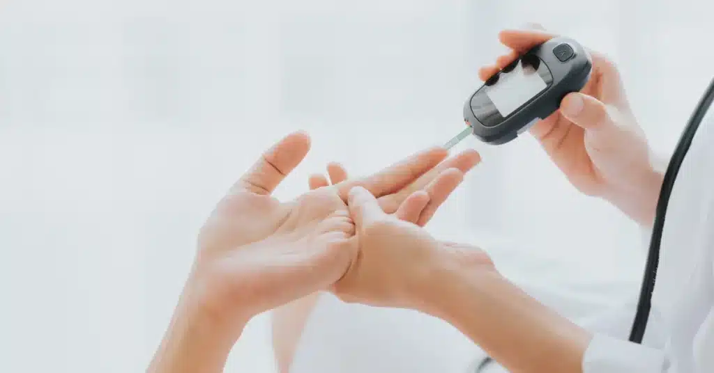 Doctor Use Glucometer Checking Blood Sugar Level From Patient Hand